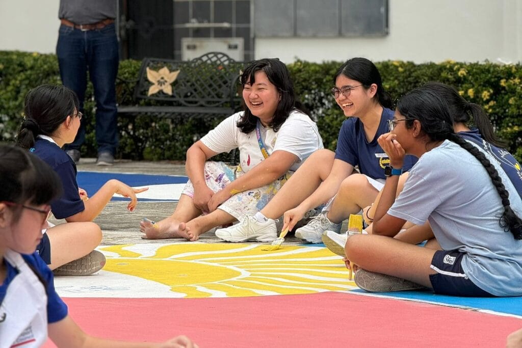 At the end of a workshop series, Dorcas and volunteers paint “The Light Within Us,” a community mural in Ghim Moh. Photo Courtesy of The Roving Studio, Ian Mun.