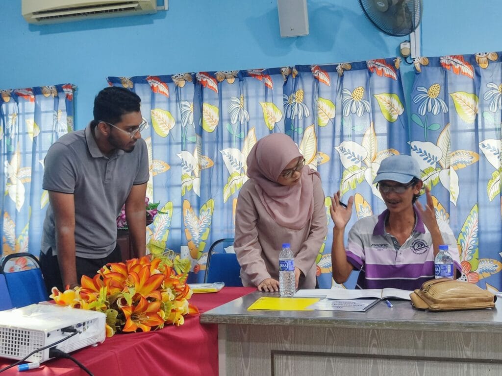 Prasaad listens to rural fish breeder's complaint. Photo courtesy of AquaTech.