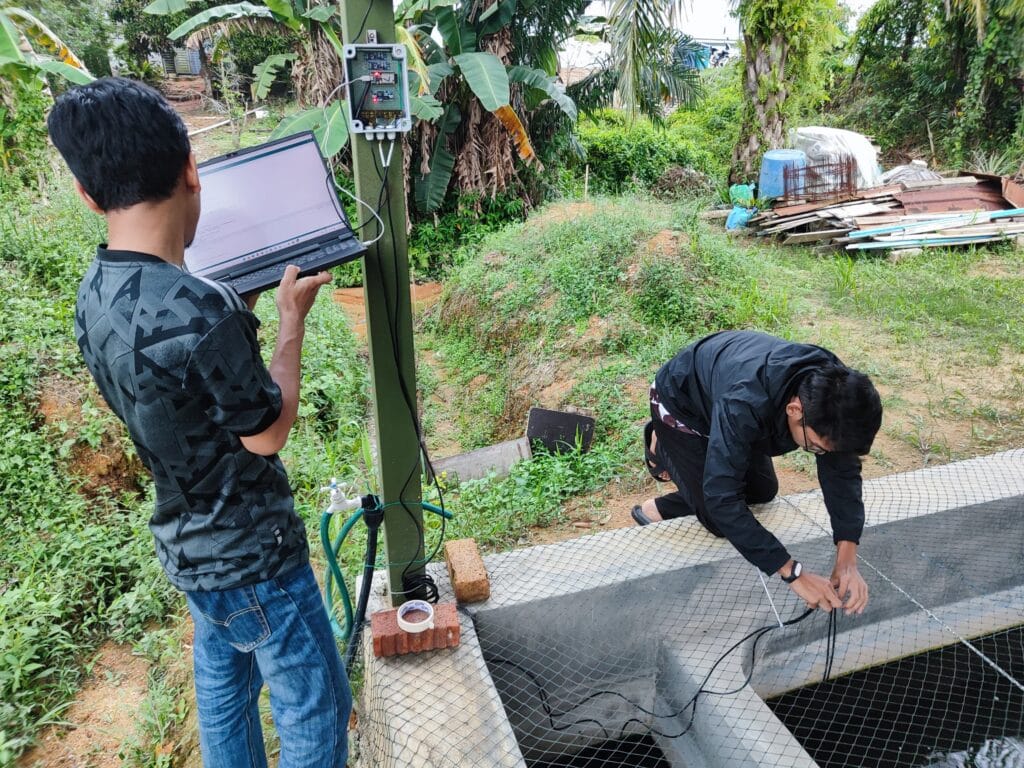 Prasaad and Azim sets up the Water Monitoring System. Photo courtesy of AquaTech.