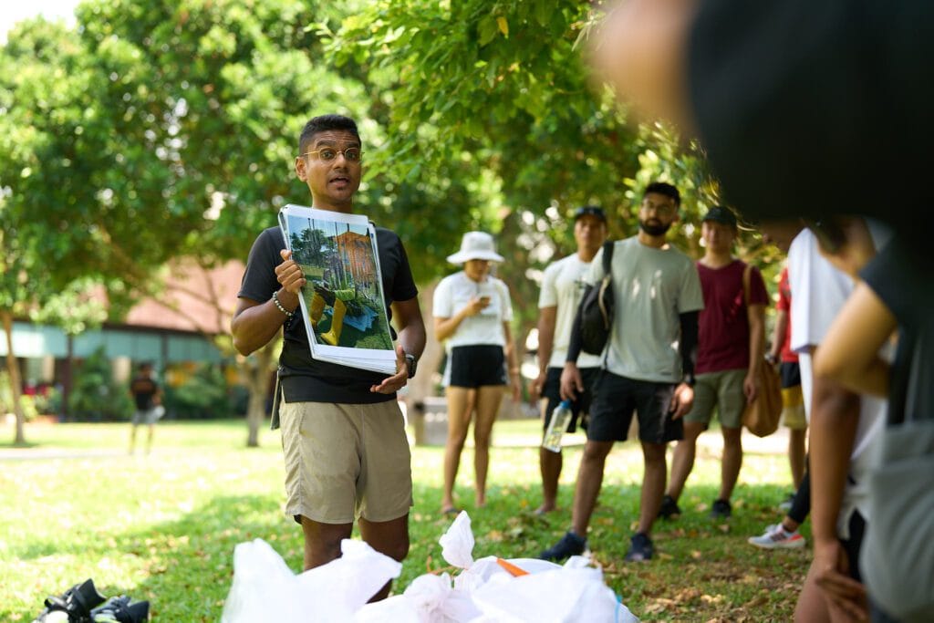 Yasser holding photo instructions for clean-up volunteers